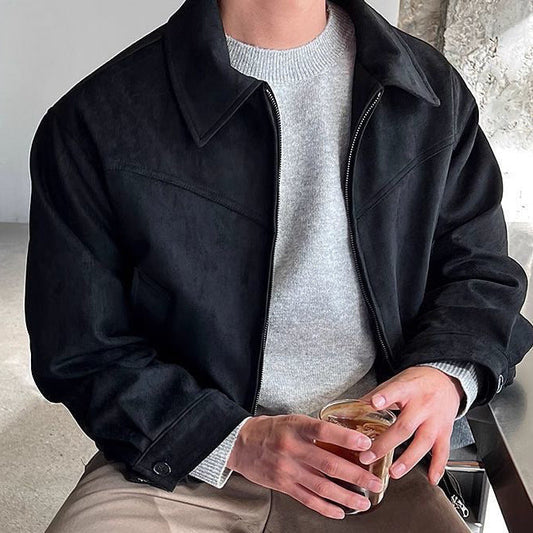 Man wearing a black faux leather zip jacket