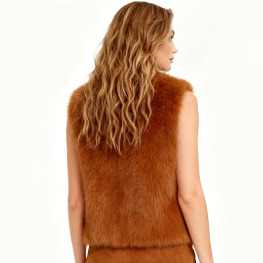 Woman wearing a cropped cognac faux fur vest with a leather look lapel collar