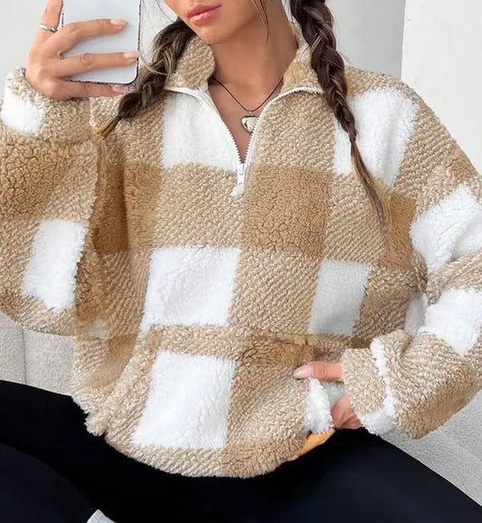 Woman wearing a plaid knit half zip sweater