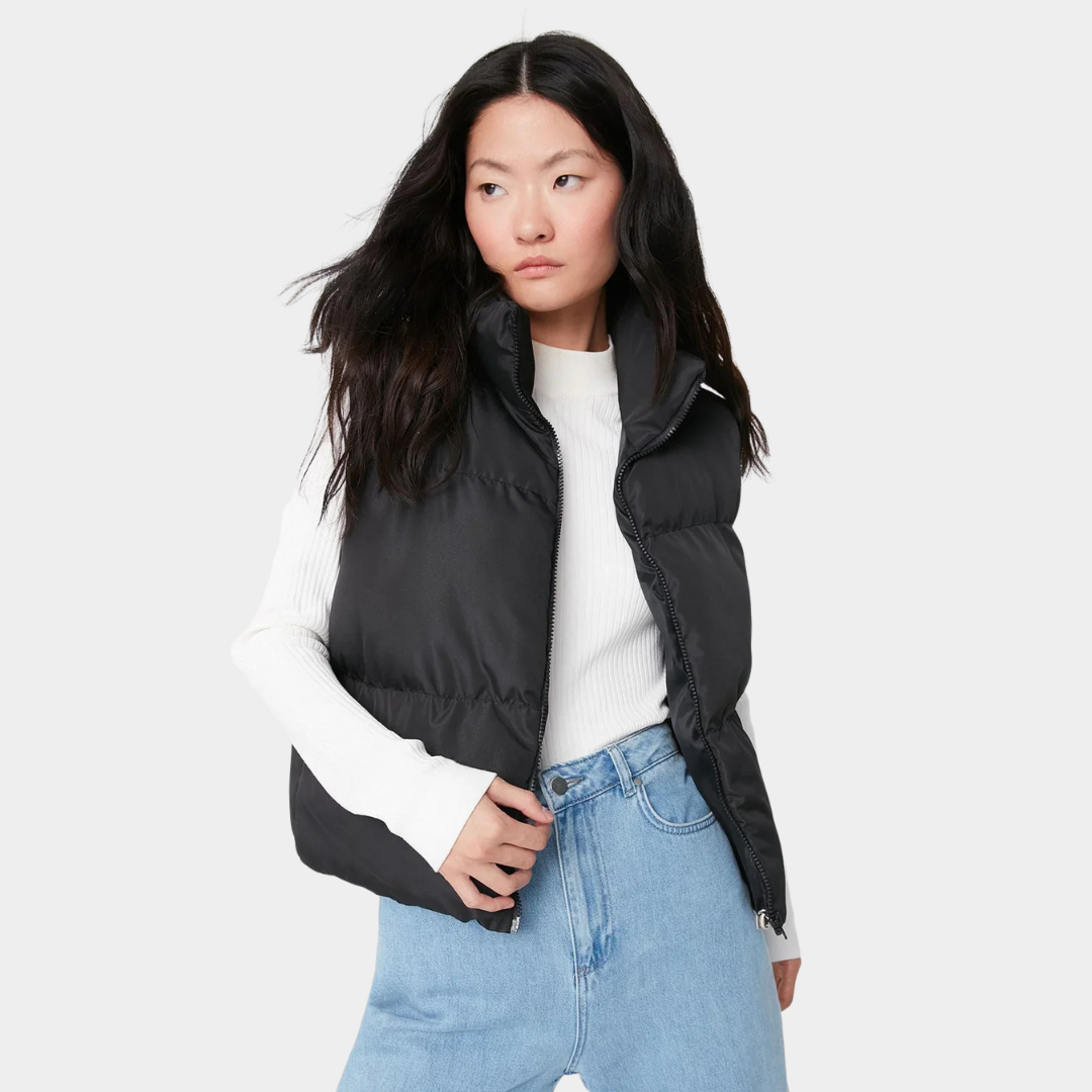 Woman wearing a lightweight quilted high collar vest