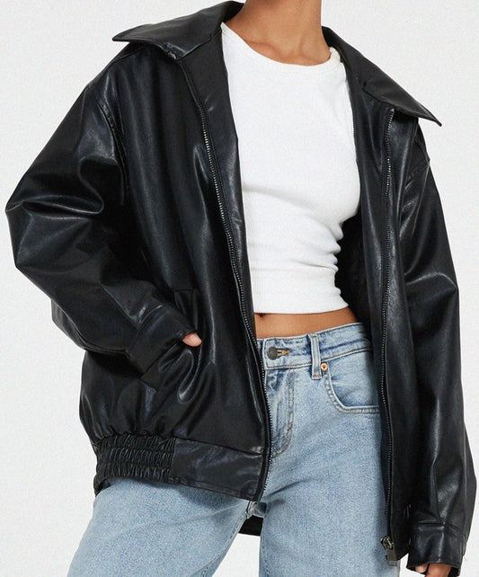 Woman wearing an oversized faux leather bomber jacket