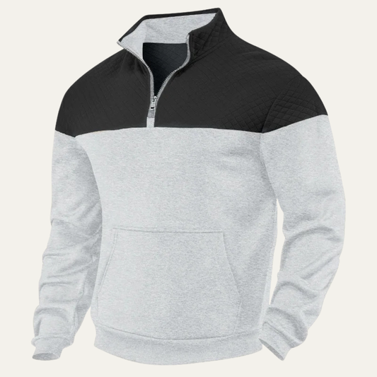 Man wearing a quilted color block half zip sweater