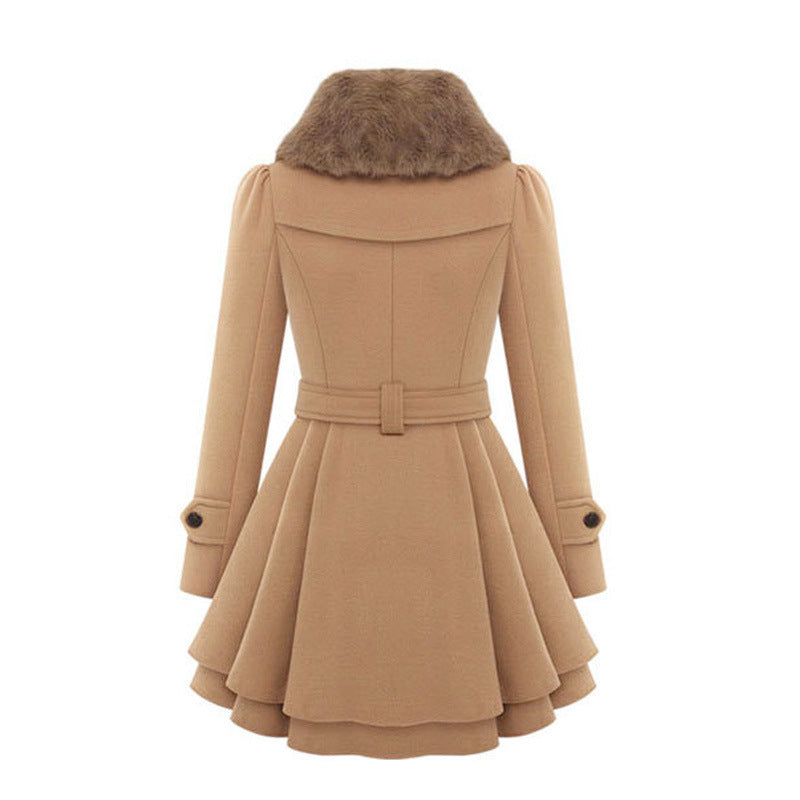 Woman wearing a double-breasted coat with a plush faux fur collar