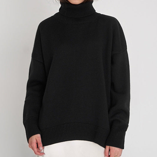 Woman wearing an oversized turtleneck knit sweater