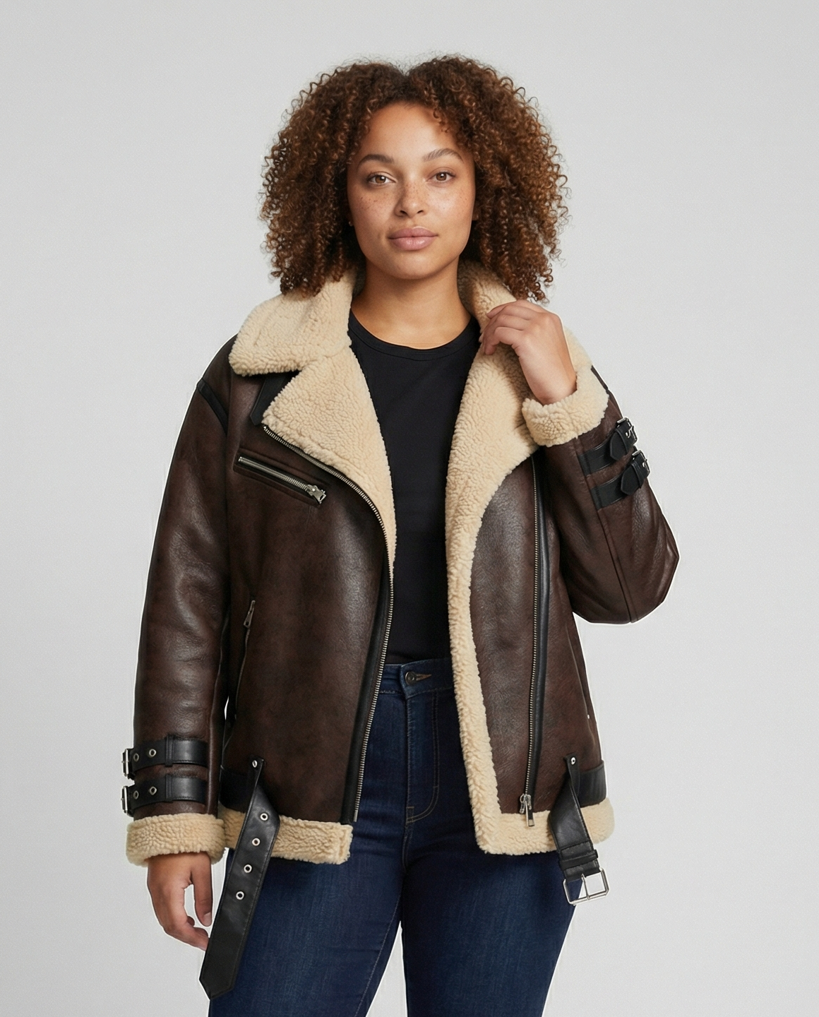 Woman wearing a brown faux leather moto jacket