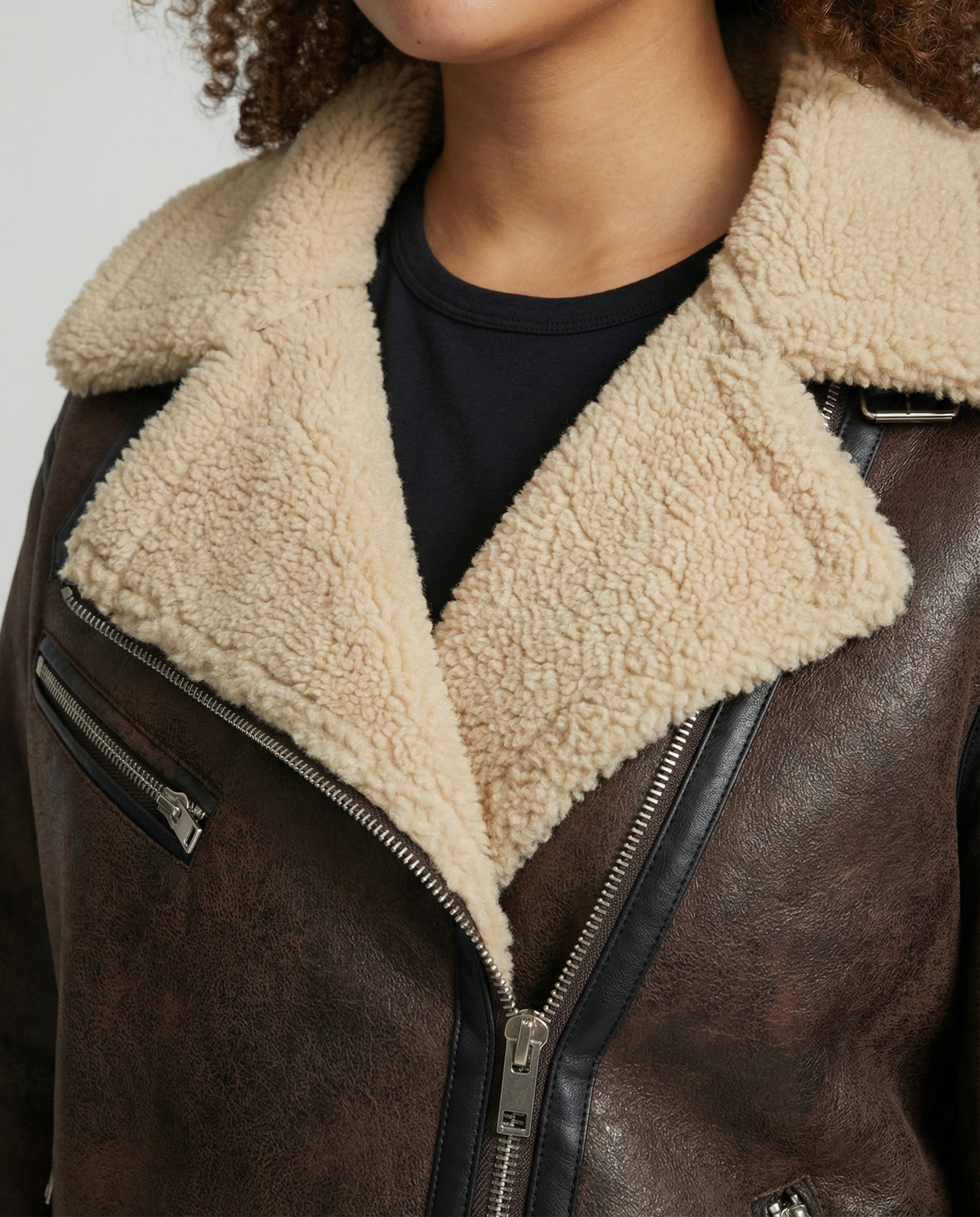 Woman wearing a brown faux leather moto jacket