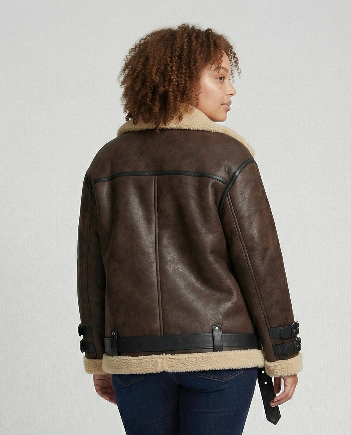 Woman wearing a brown faux leather moto jacket