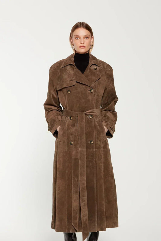 Woman wearing a long suede double-breasted belted trench coat