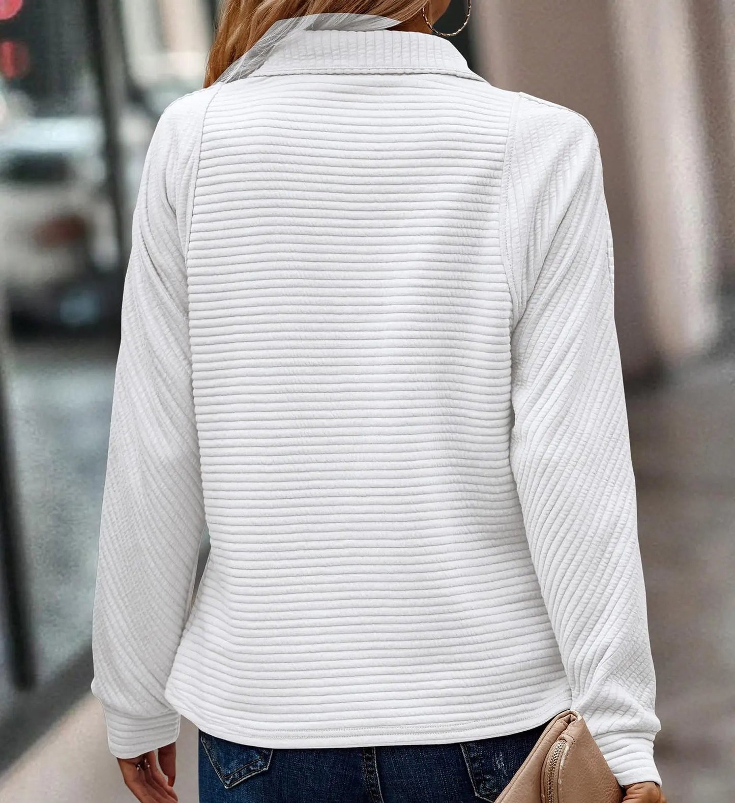 Woman wearing a ribbed half zip pullover sweater