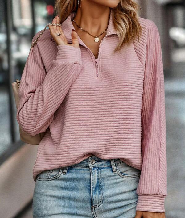 Woman wearing a ribbed half zip pullover sweater