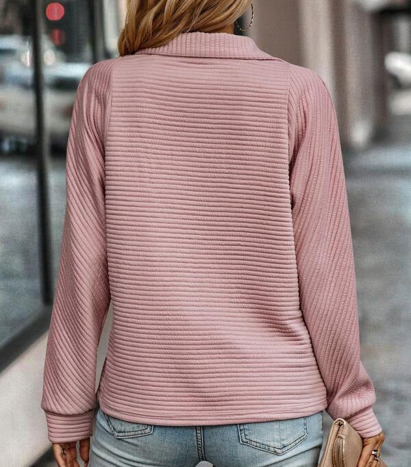 Woman wearing a ribbed half zip pullover sweater