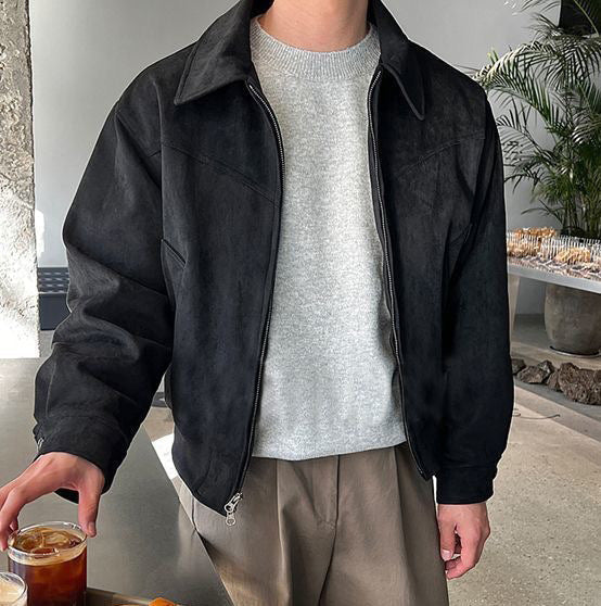 Man wearing a black faux leather zip jacket