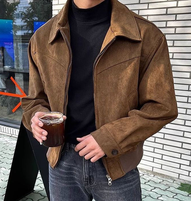 Man wearing a black faux leather zip jacket