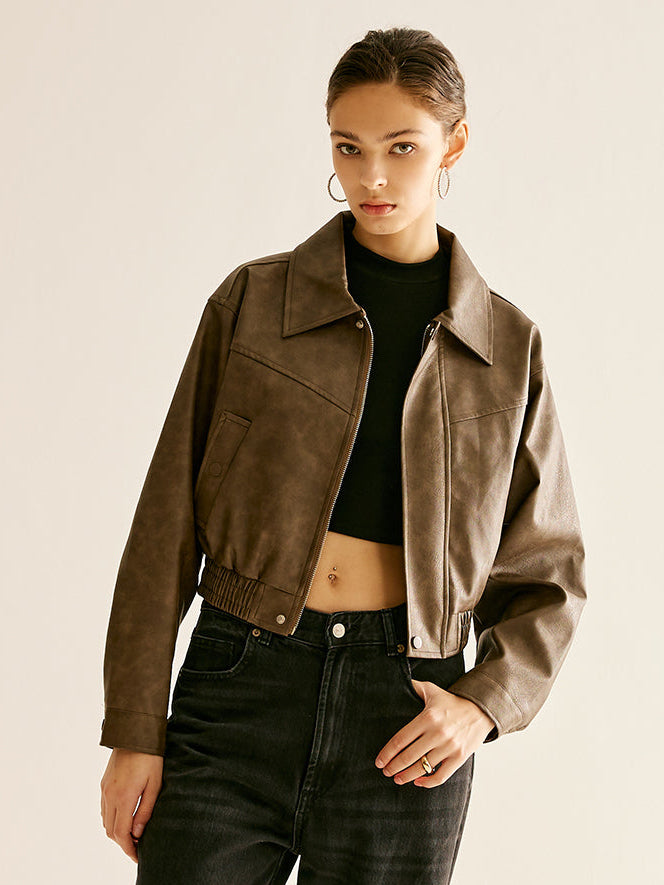 Woman wearing a brown faux leather biker jacket