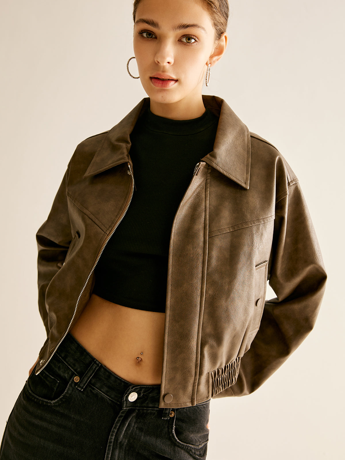 Woman wearing a brown faux leather biker jacket