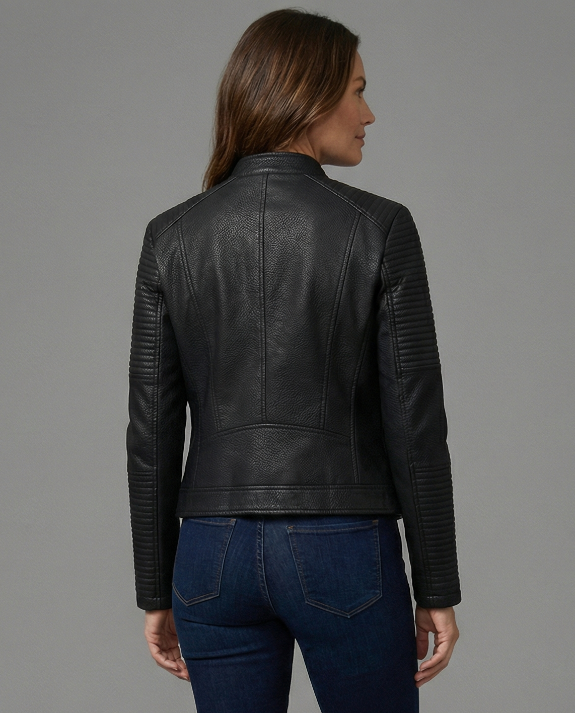 Woman wearing a tailored black faux leather jacket