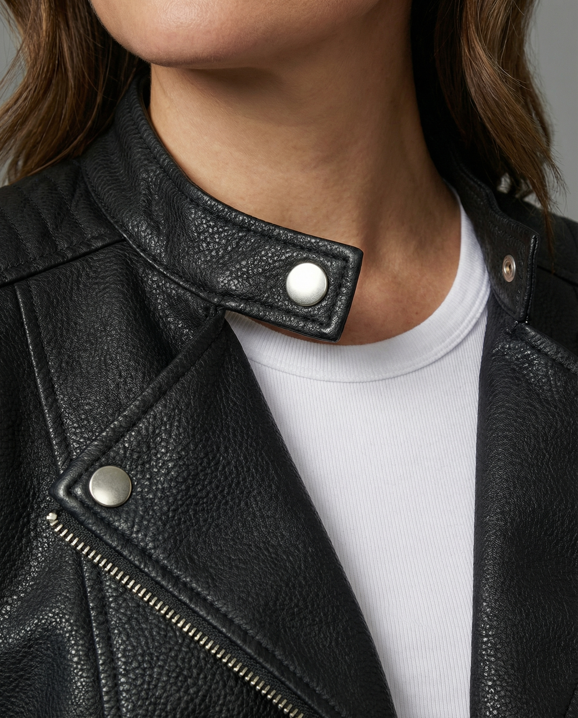 Woman wearing a tailored black faux leather jacket