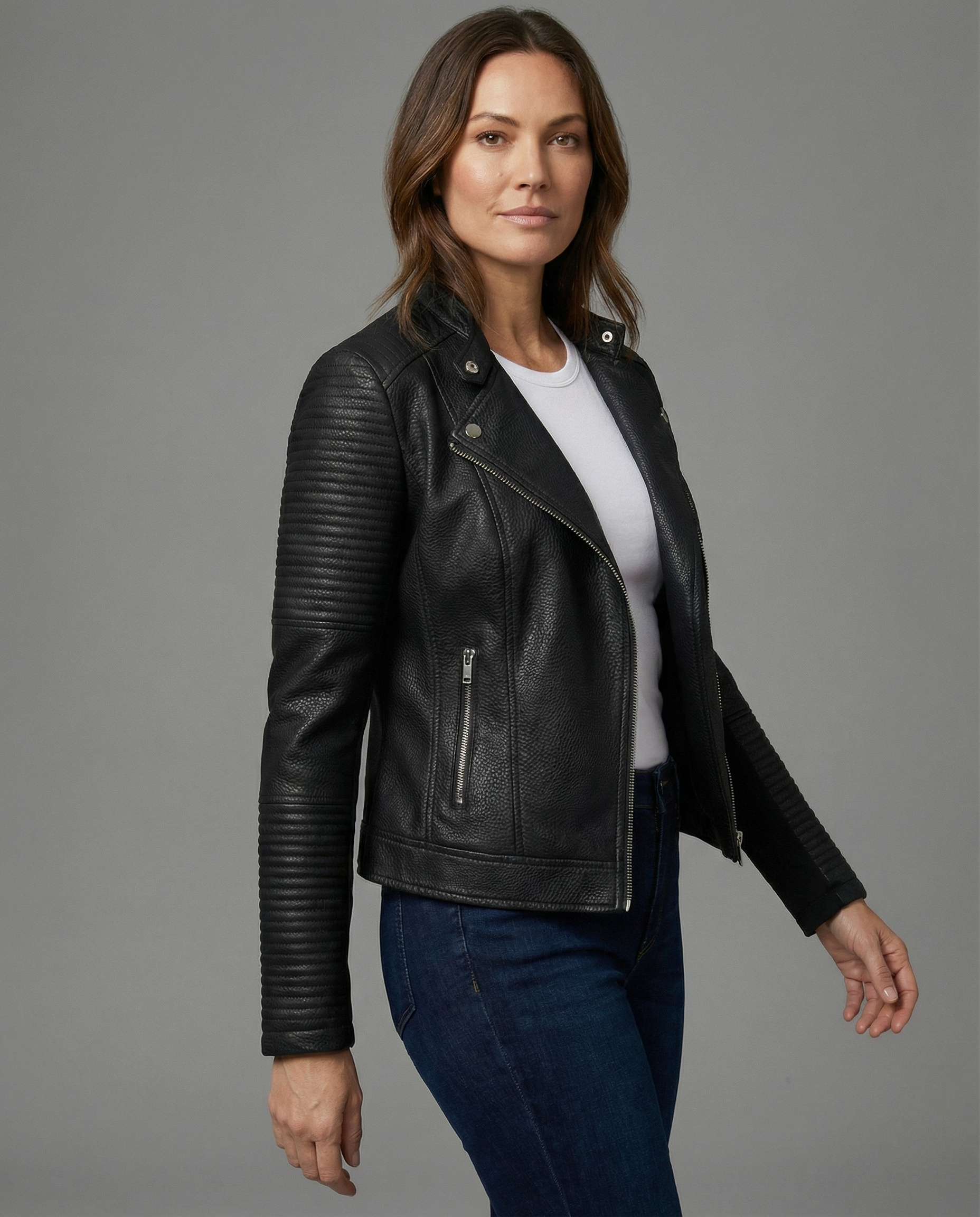 Woman wearing a tailored black faux leather jacket