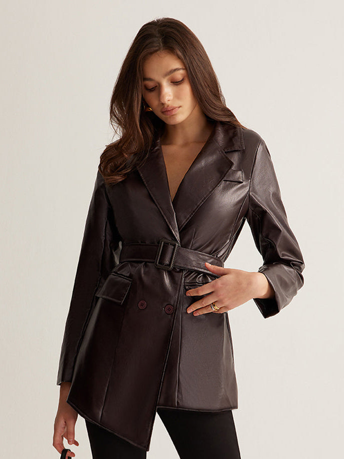 Woman wearing a belted burgundy faux leather jacket