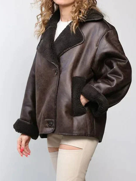 Woman wearing a draped brown faux leather jacket
