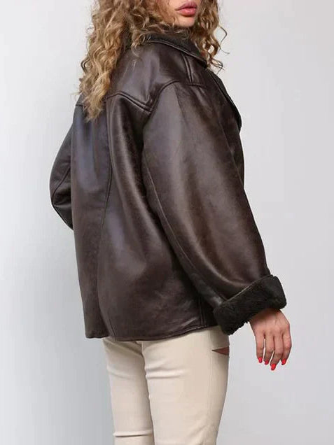 Woman wearing a draped brown faux leather jacket