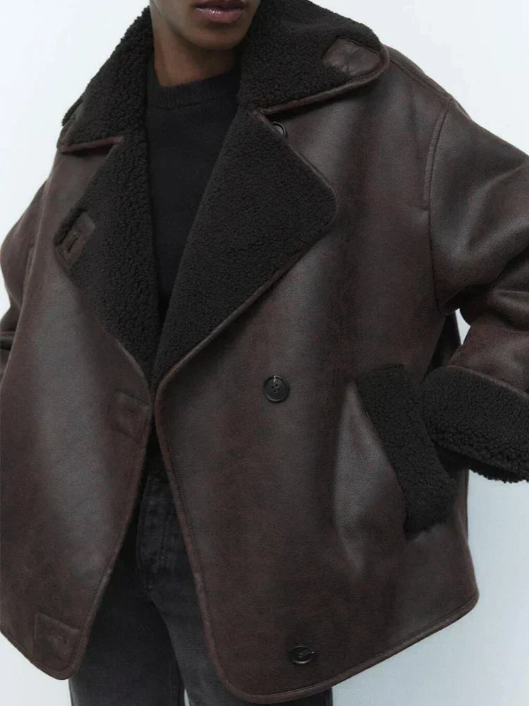 Woman wearing a draped brown faux leather jacket