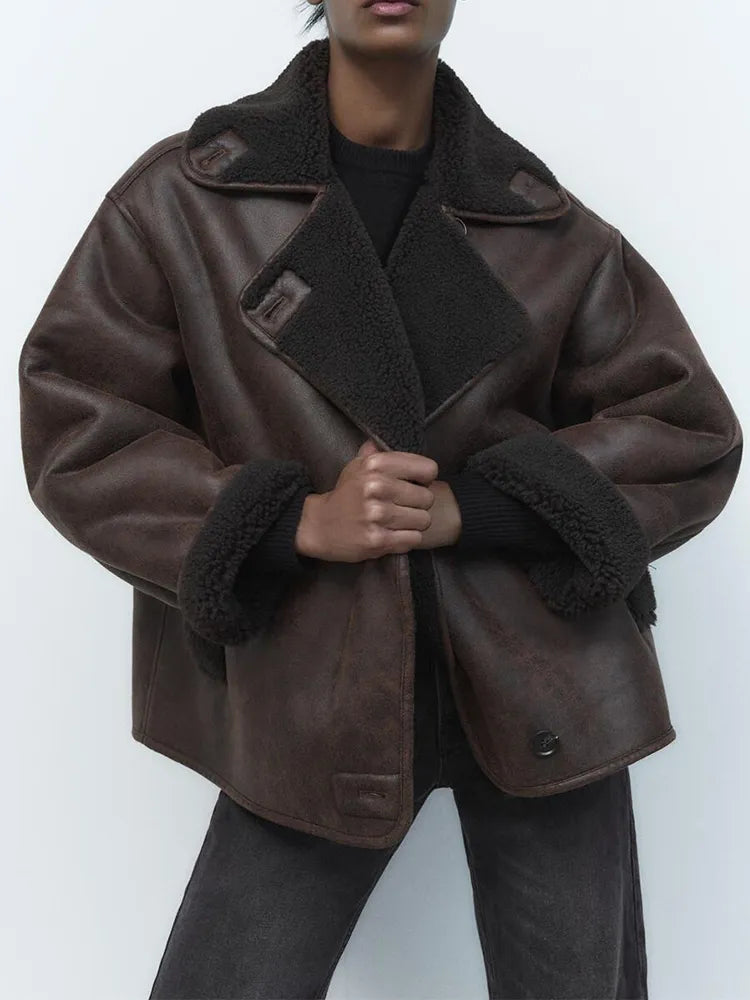 Woman wearing a draped brown faux leather jacket