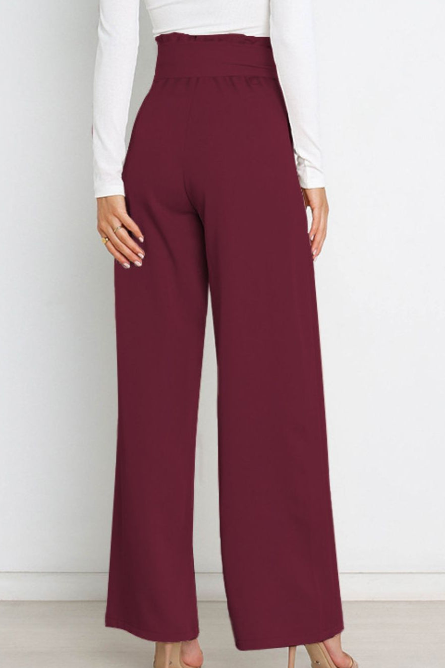 Woman wearing paperbag waist wide leg pants