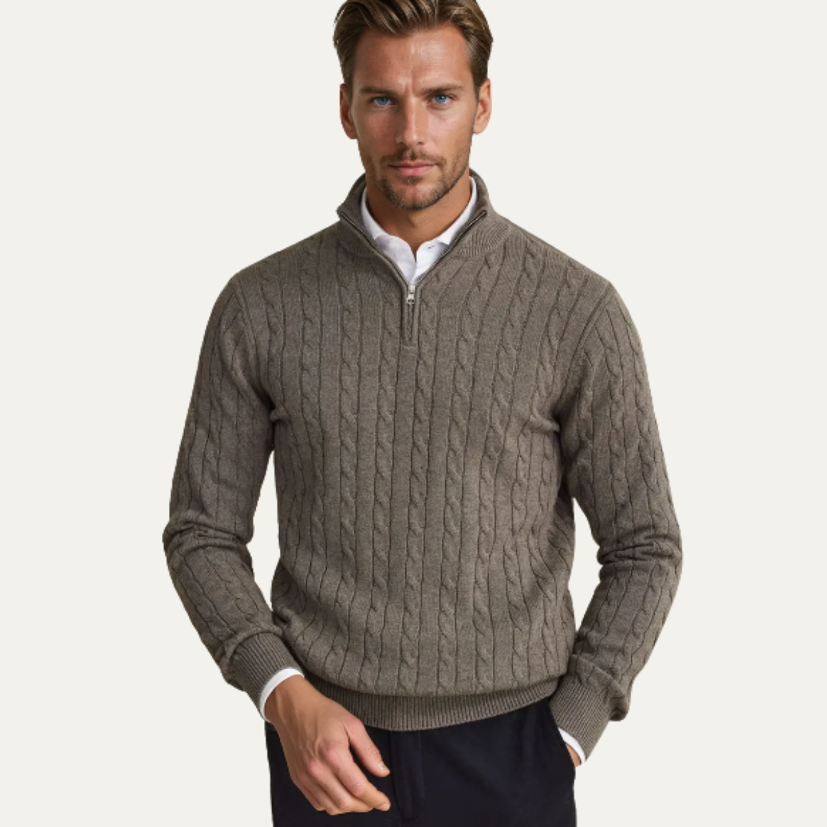 Man wearing a cable knit quarter zip sweater