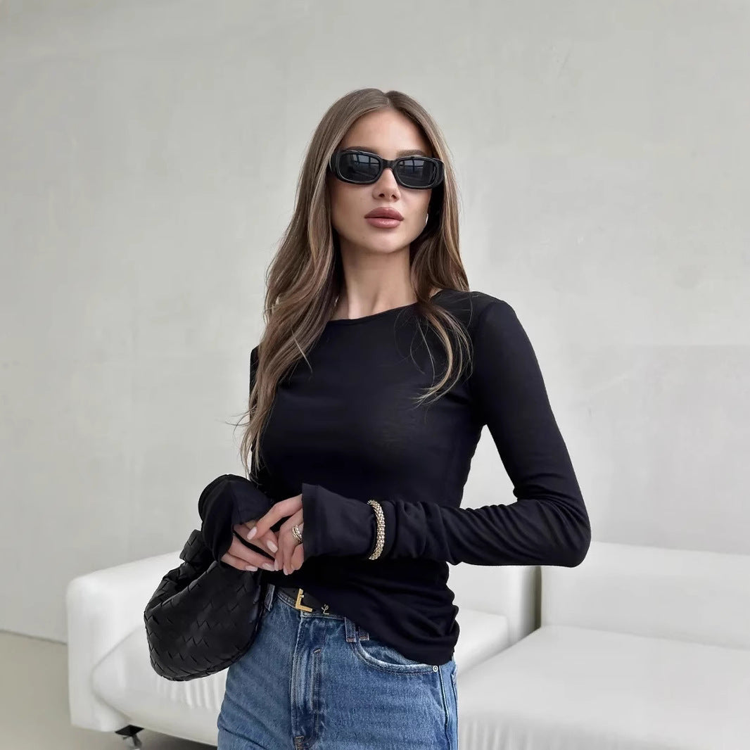 Woman wearing a long sleeve round neck thumbhole top