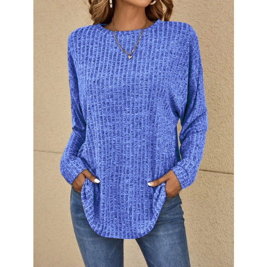 Woman wearing a loose fit long sleeve round neck top