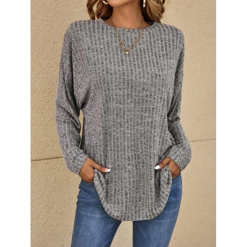 Woman wearing a loose fit long sleeve round neck top