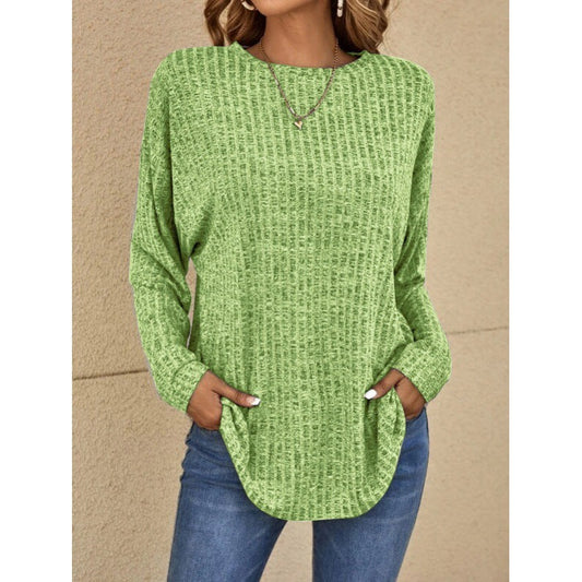 Woman wearing a loose fit long sleeve round neck top