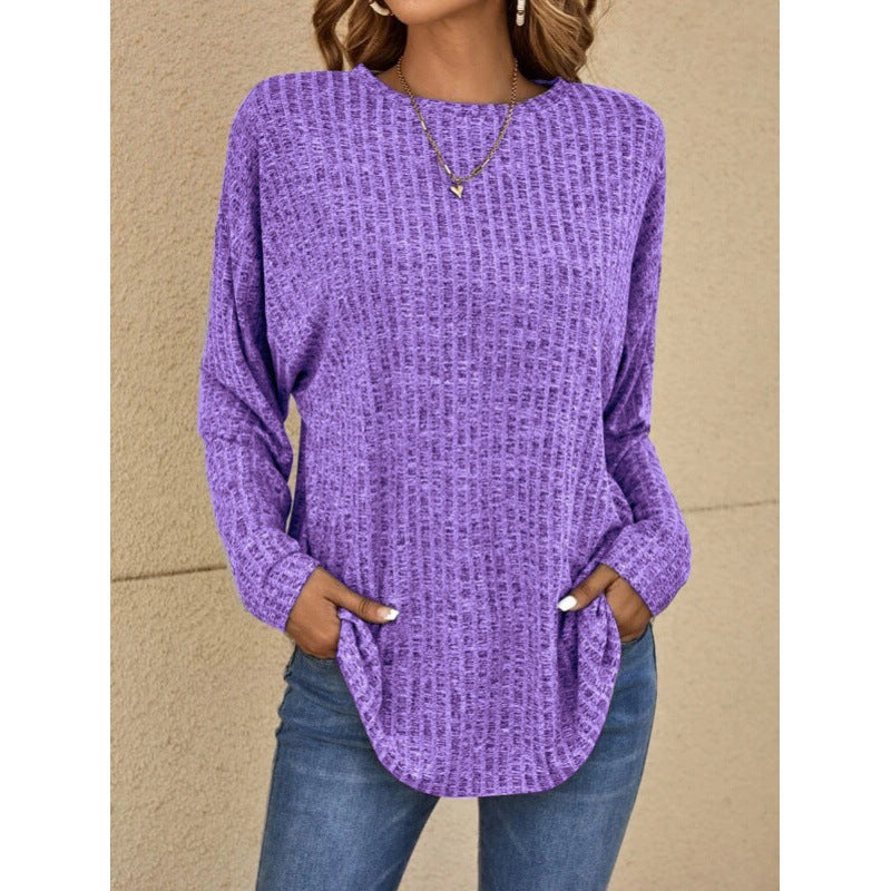 Woman wearing a loose fit long sleeve round neck top