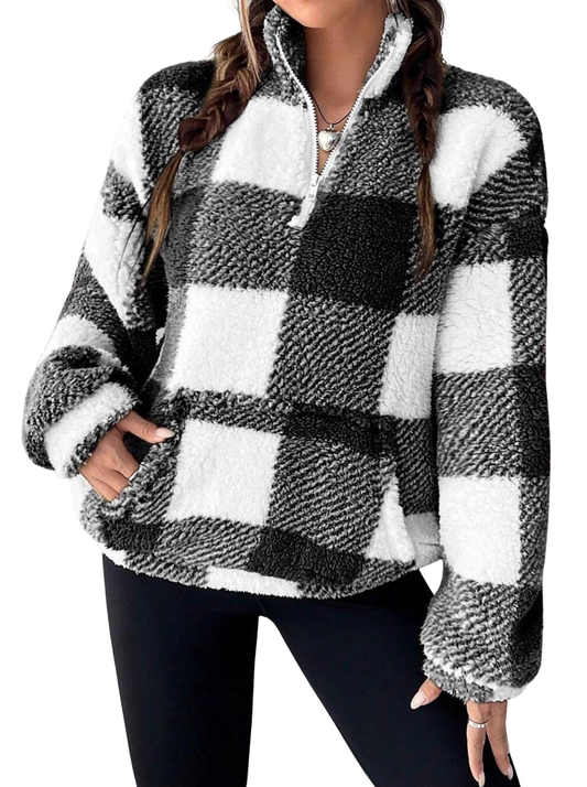 Woman wearing a plaid half zip sweater