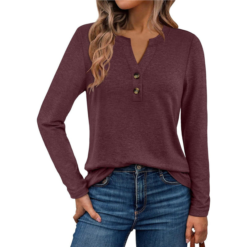 Woman wearing a V-neck long sleeve t-shirt with button detail