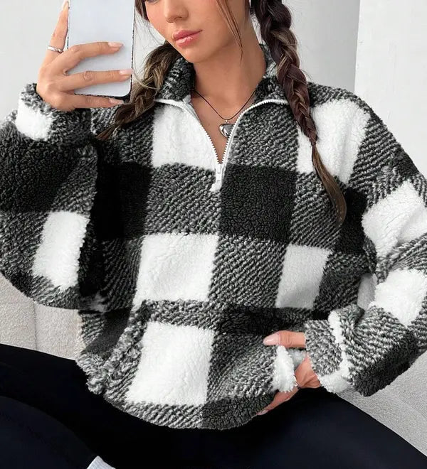 Woman wearing a plaid knit half zip sweater