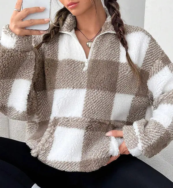 Woman wearing a plaid knit half zip sweater