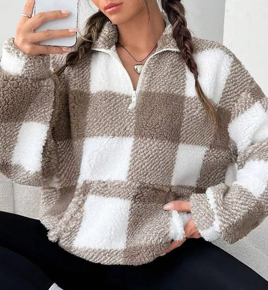 Woman wearing a plaid knit half zip sweater