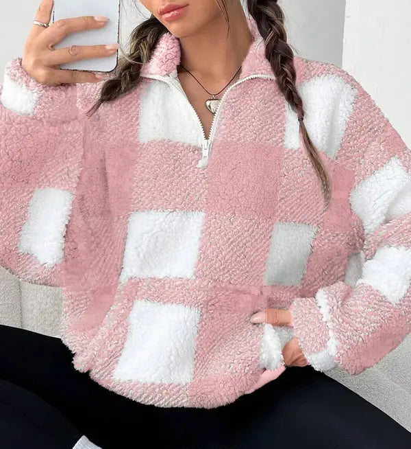 Woman wearing a plaid knit half zip sweater