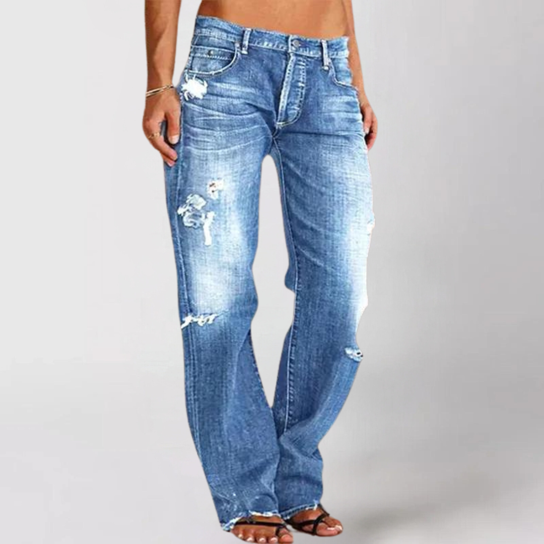 Woman wearing relaxed wide leg distressed denim jeans