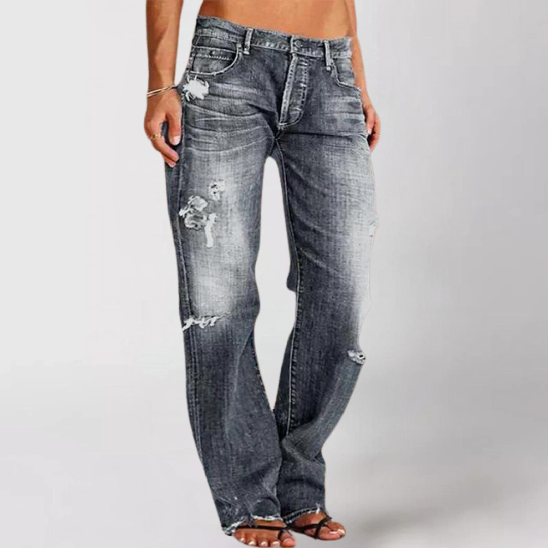 Woman wearing relaxed wide leg distressed denim jeans