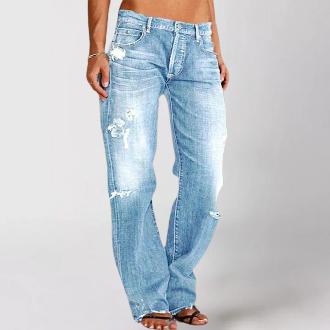 Woman wearing relaxed wide leg distressed denim jeans