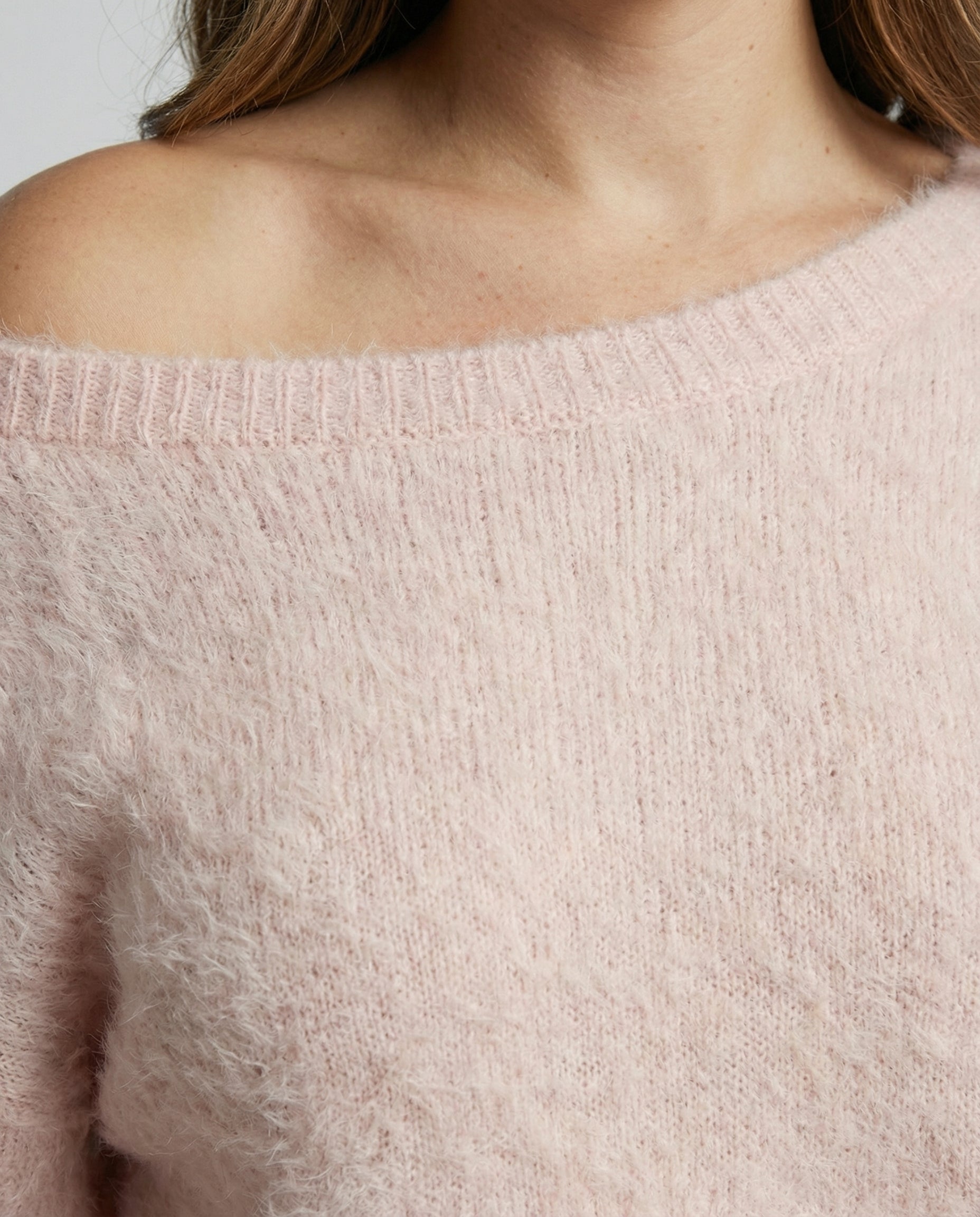 Woman wearing a fuzzy knit oversized sweater