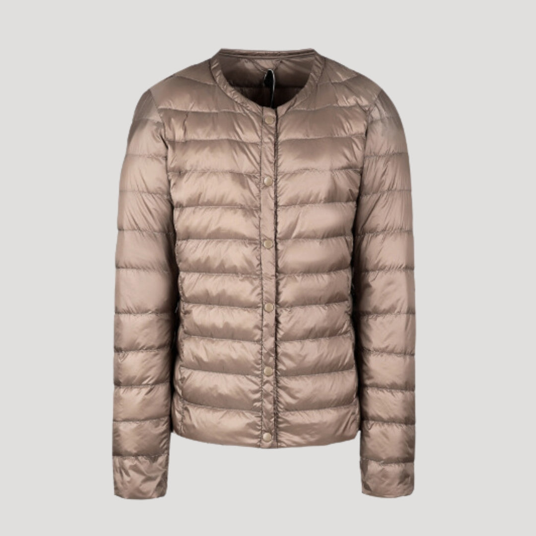 Woman wearing a lightweight collarless quilted puffer jacket