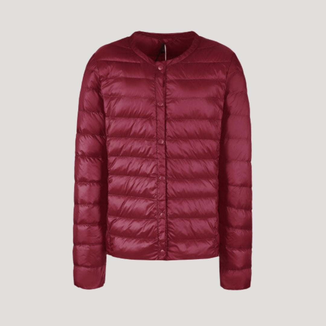 Woman wearing a lightweight collarless quilted puffer jacket