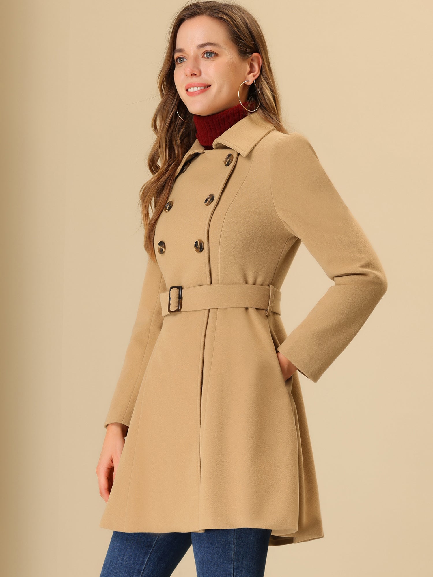 Woman wearing a double-breasted flared mid-length trench coat with notched collar