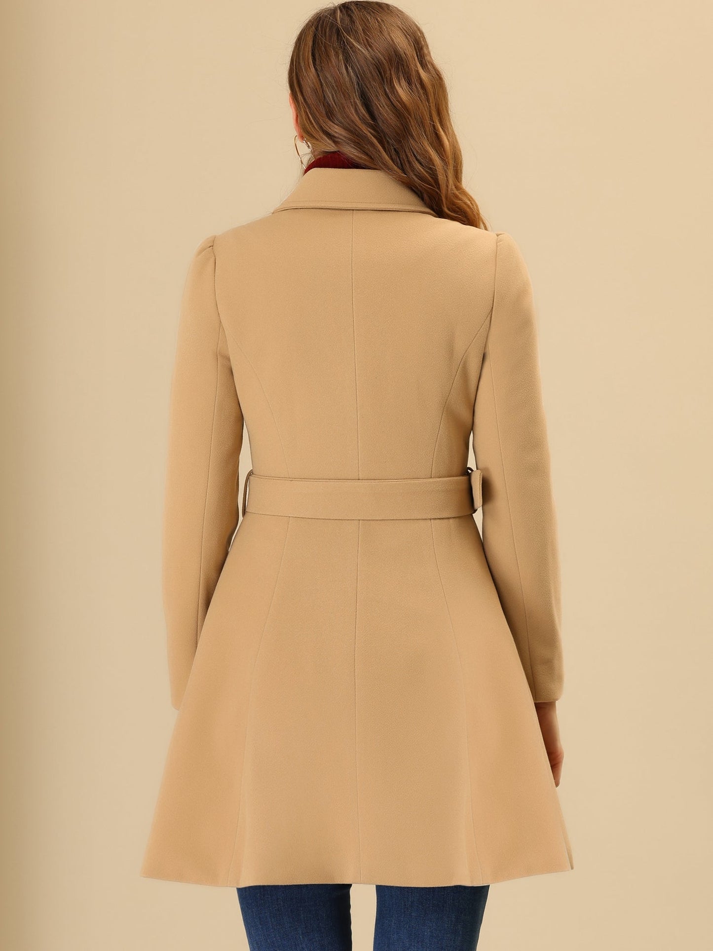 Woman wearing a double-breasted flared mid-length trench coat with notched collar