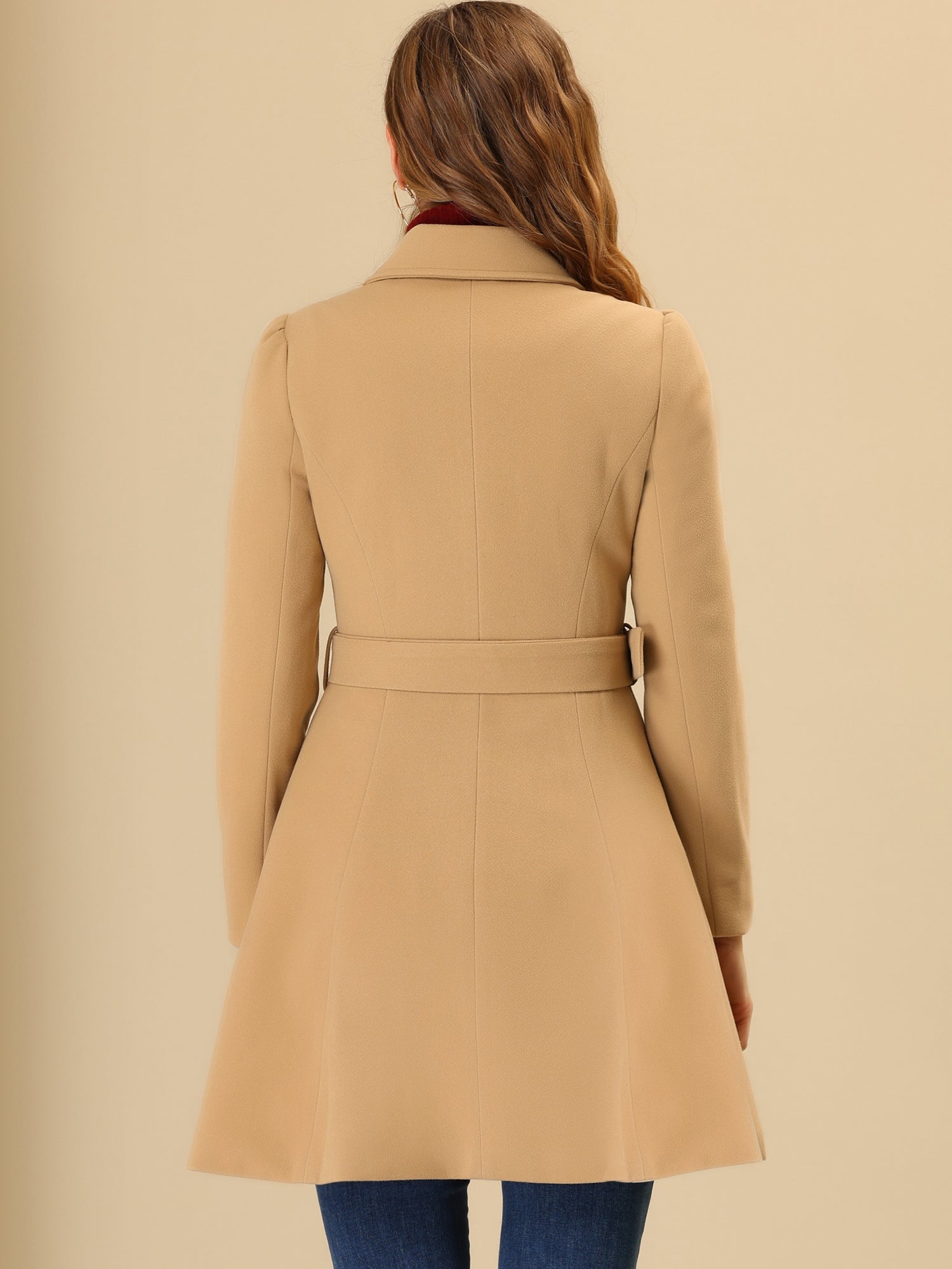 Woman wearing a double-breasted flared mid-length trench coat with notched collar