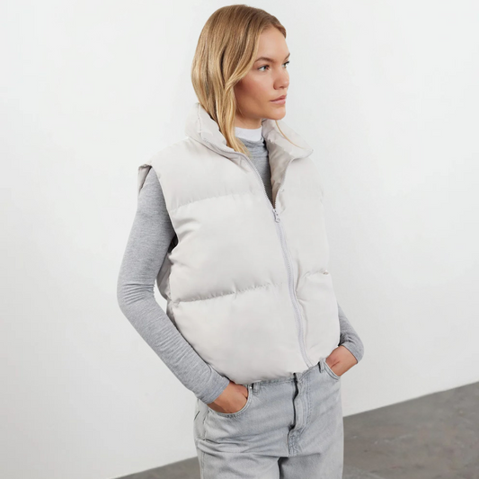 Woman wearing a lightweight quilted high collar vest